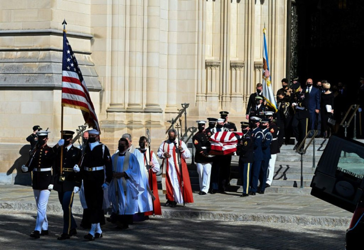 The casket leaves the Washington National Cathedral followed by family members