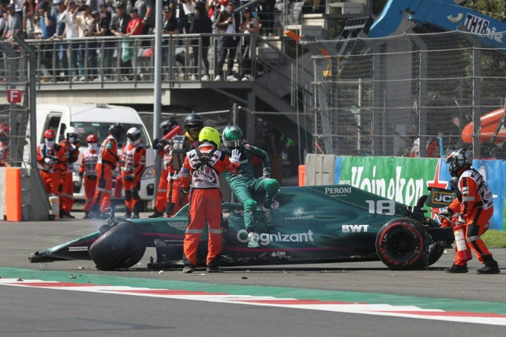 Wall marked: Aston Martin's Lance Stroll steps out of his car after crashing in the first session