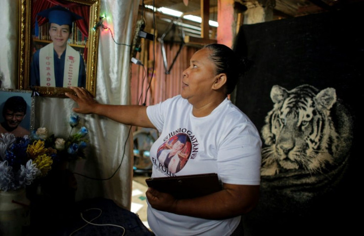 Aura Lila Lopez looks at photos of her son Junior Gaitan, who was shot during protests against Nicaraguan President Daniel Ortega's government in June 2018