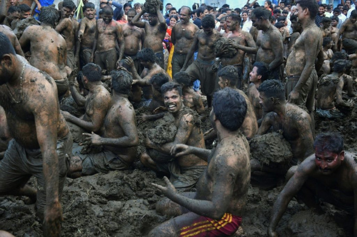 Men fling cow dung at each other during the annual 'Gore Habba' festival, marking the end of the Hindu festival of Diwali