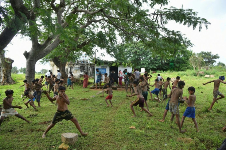 Boys fling cow dung each other to mark the start of the 'Gore Habba' festival