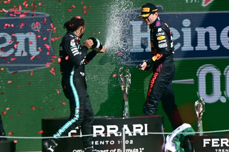 The battle continues: Lewis Hamilton (left) and Max Verstappen spray each other with champagne on the podium