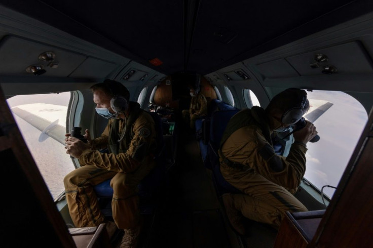 Flying above the Yellow Sea between Korea and China, a French naval crew scans the ocean surface for signs of contraband headed for North Korea