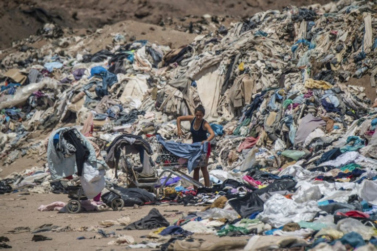 Women search for used clothes amid tons discarded in the Atacama desert, in Alto Hospicio, Iquique, Chile