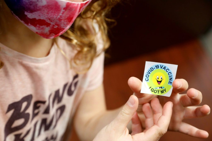 A seven-year-old child after getting the Pfizer-BioNTech Covid-19 vaccine in Michigan -- but the decision can spark legal battles between divorced parents