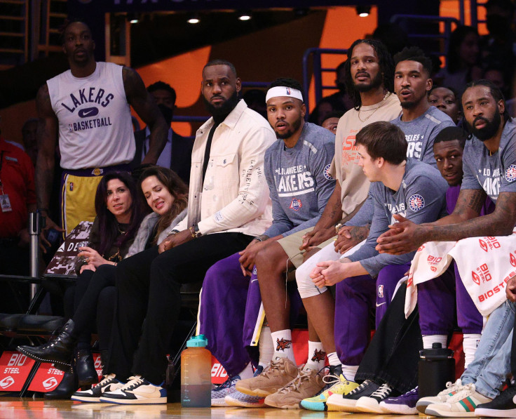 An injured LeBron James #6 of the Los Angeles Lakers watches from the bench