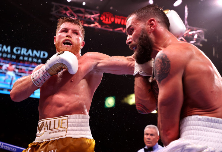 Canelo Alvarez (L) punches Caleb Plant during their championship bout for Alvarez's WBC, WBO and WBA super middleweight titles and Plant's IBF super middleweight title at MGM Grand Garden Arena