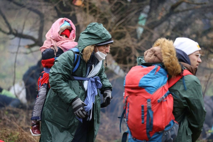 Women and small children are among those camped out in the cold: the Polish government claims the migrants may try to storm the border by force