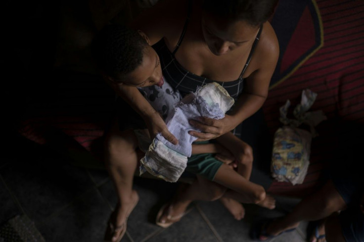 Vanessa Moraes, 39, shows how she uses a diaper and a towel as a substitution for a sanitary pad