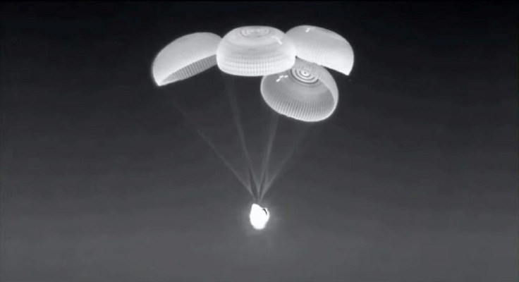 This screen grab taken from the SpaceX live webcast shows the Crew-2 SpaceX Dragon capsule, dubbed "Endeavour," with its parachutes deployed just before splashing down off the coast of Pensacola, Florida, on November 8, 2021