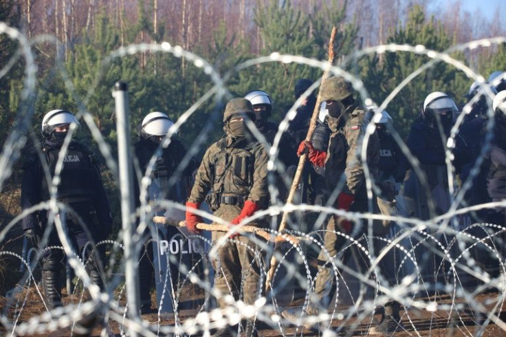 Hundreds of desperate migrants are trapped in freezing weather on the Belarus-Poland border, where the presence of troops has raised fears of a confrontation