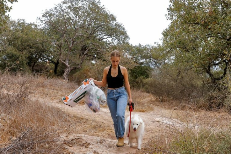 For each bag Elishya Ben Meir fills in the valley near her home in Israel, she receives around 10 'Clean Coins', a virtual currency that can be redeemed for goods from participating businesses