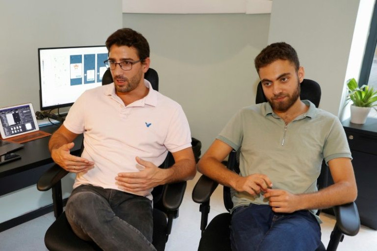 (L to R) Clean Coin co-founders Adam Ran and Gal Lahat are pictured at their office in Israel's northern city of Haifa. The company says more than 16,000 users have already signed up