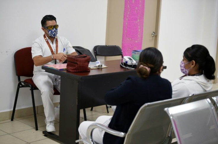Transgender nurse Karim Gutierrez speaks with colleagues at Mexico's first public clinic for trans patients