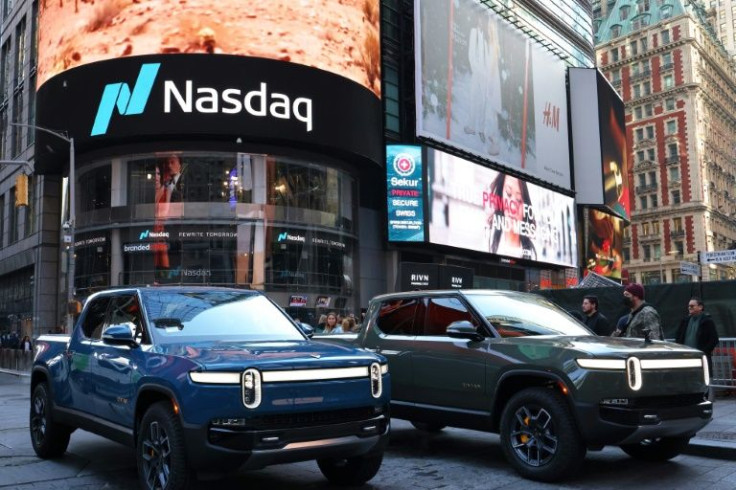 Rivian electric trucks are seen parked near the Nasdaq MarketSite building in Times Square, in New York City