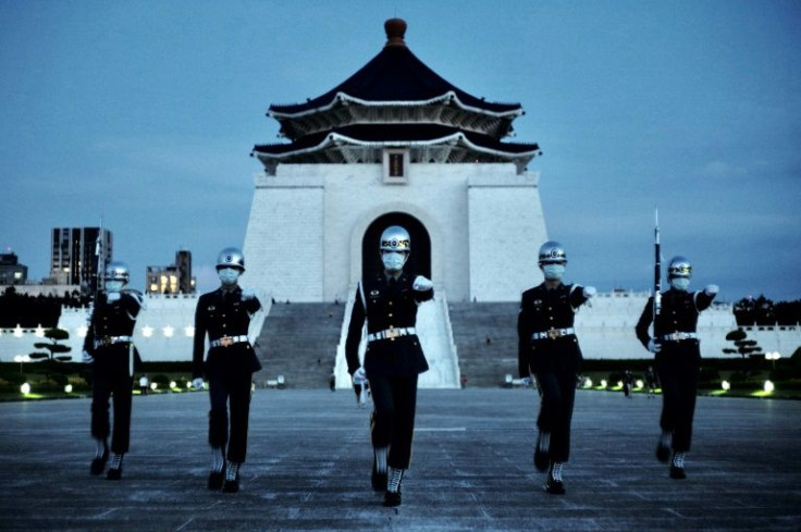 Guards march in front of the Chiang Kai-shek Memorial Hall in Taipei