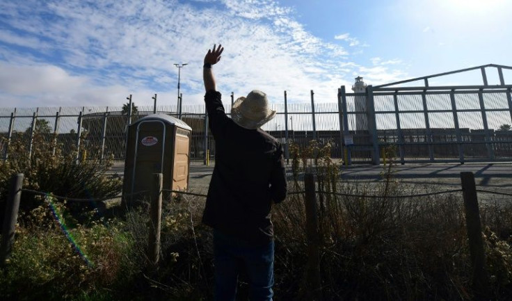 Pastor Set Clark raises his hand during Sunday Mass communicating with followers across the US-Mexico border in Imperial Beach, California on November 7, 2021