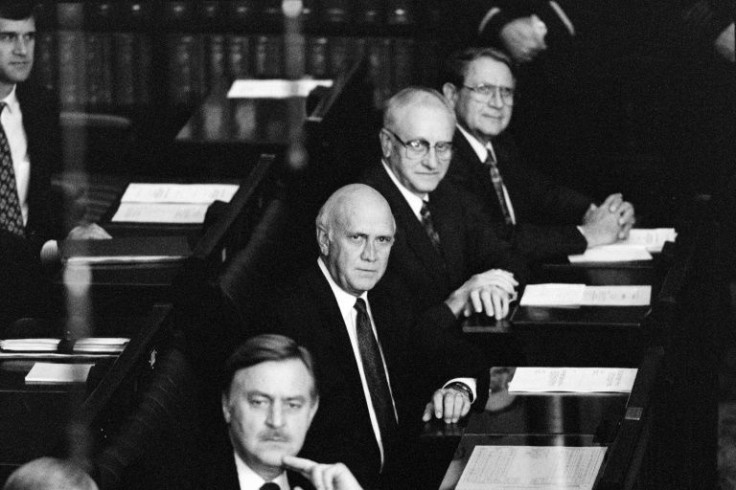 Late President De Klerk (C) listens in Cape Town during the last "white" parliament session on December 22, 1993