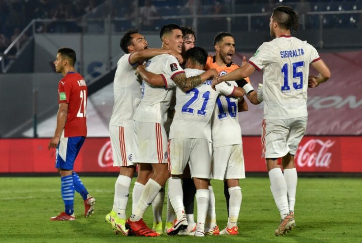 Chile's players celebrate after a third straight win pushed them into the automatic World Cup qualification spots