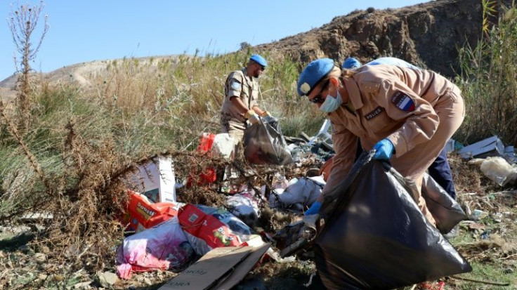 Volunteers join UN peacekeepers in cleaning up an illegal dump site in the UN-patrolled buffer zone that divides the Mediterranean island of Cyprus