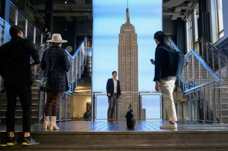 Visitors take pictures at the Empire State Building on November 9, 2021 in New York, New York