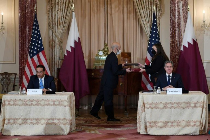 US Secretary of State Antony Blinken (right) and Qatar's Foreign Minister Sheikh Mohammed bin Abdulrahman Al Thani sign an agreement on Afghanistan cooperation