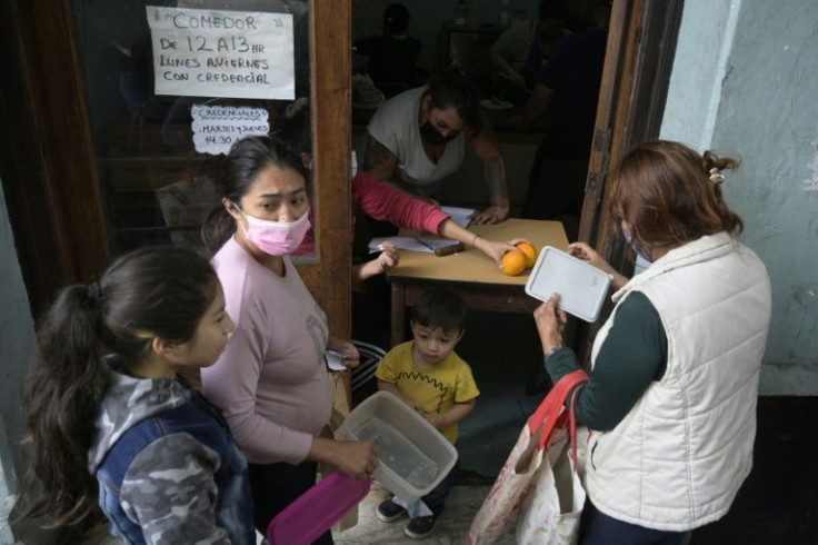 People wait for free food at the state-supported soup kitchen in the working class La Boca neighborhood of Buenos Aires