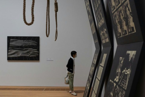 A woman looks at Suicide Project by Wei Guangqing on the opening day of the M+ art museum in Hong Kong