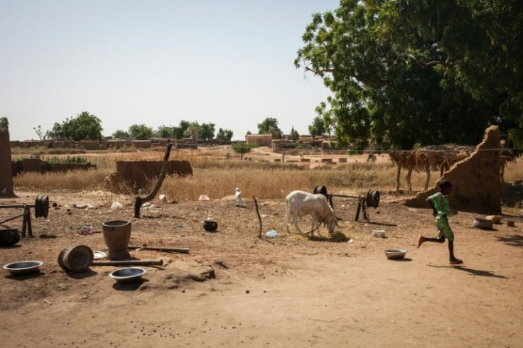 A child runs through destroyed houses in the Malian village of Ogossagou