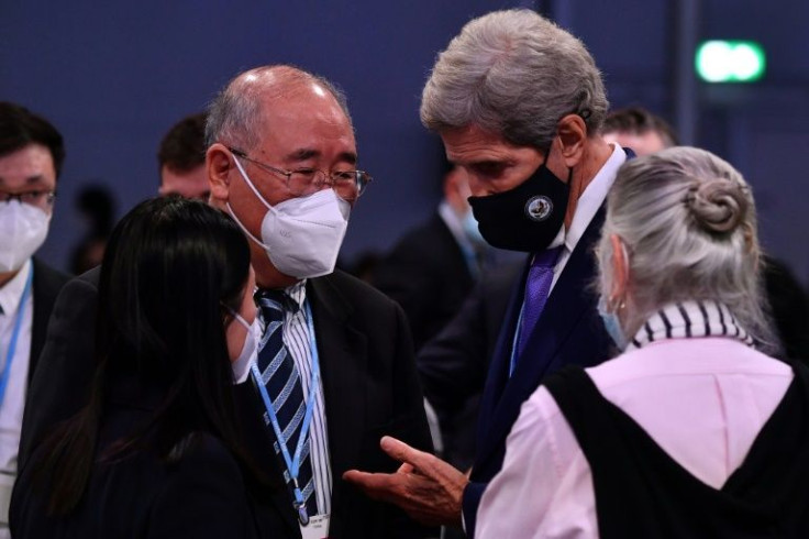 US special climate envoy John Kerry speaks with China's special climate envoy Xie Zhenhua on the final day of COP26