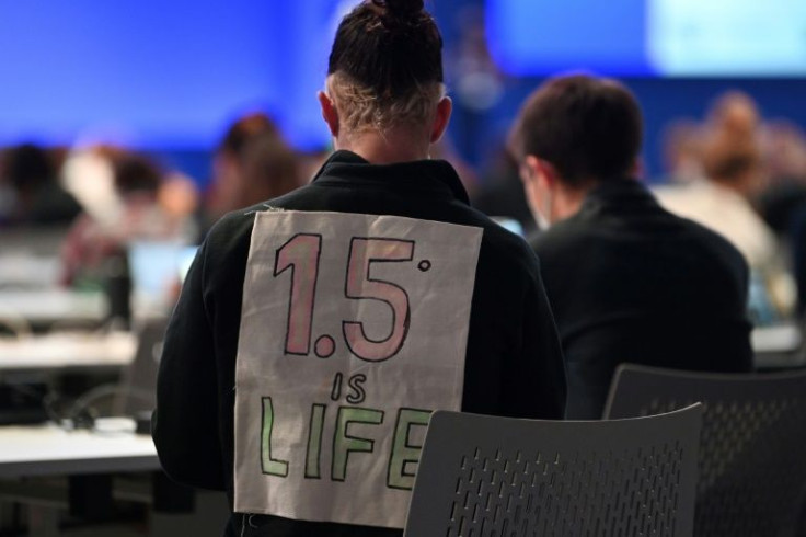A delegate bearing a message on his back "1.5C is life" attends the People's Plenary during the COP26 UN Climate Change Conference in Glasgow
