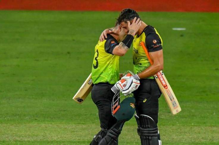 Men in the middle: Australia's Marcus Stoinis (right) and Matthew Wade celebrate their victory over Pakistan in the semi-finals