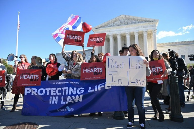 Protestors are seen outside of the US Supreme Court in Washington, DC on November 1, 2021