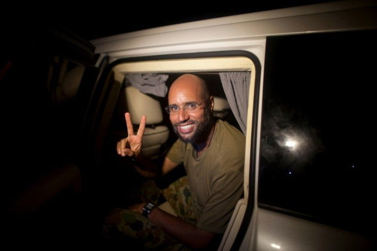 Seif al-Islam Kadhafi flashes the victory sign on August 23, 2011 as he appears in front of supporters and journalists in the Libyan capital Tripoli