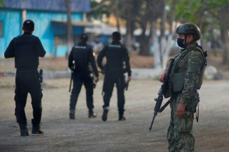 Hundreds of security personnel have ringed the prison in Guayaquil, Ecuador, where officials have regained control after a riot between inmates left at least 68 dead