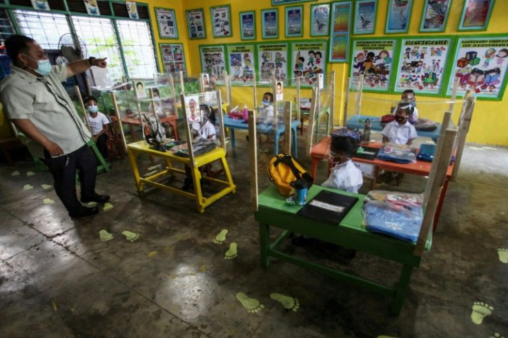 A kindergarten teacher takes a class at Siocon Elementary School in the town of Bogo in Cebu