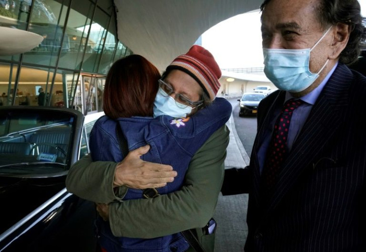 US journalist Danny Fenster (C) is reunited with his mother Rose Fenster at JFK airport after his release from a prison in Myanmar, as former US diplomat Bill Richardson looks on