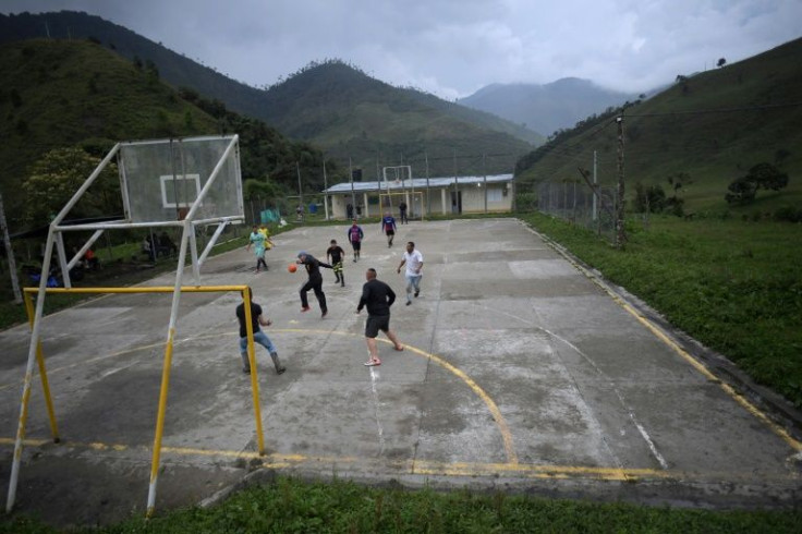 Colombian soldiers play football with locals