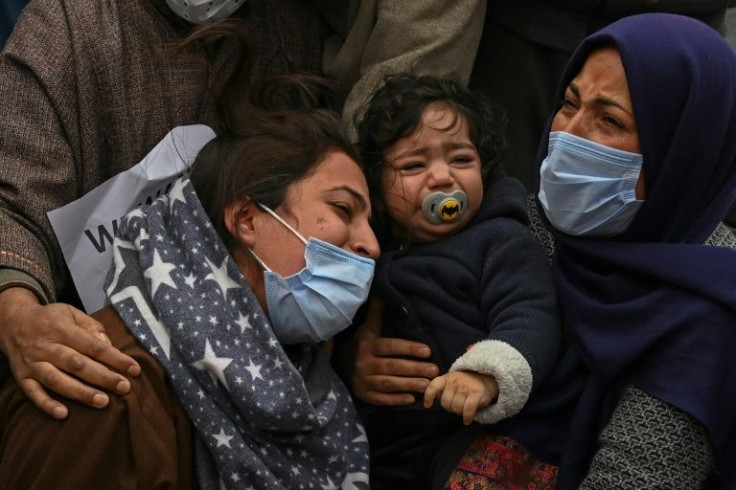 Humaira Mudasir (left), whose husband was killed in the operation, in the crowd with her daughter (centre)