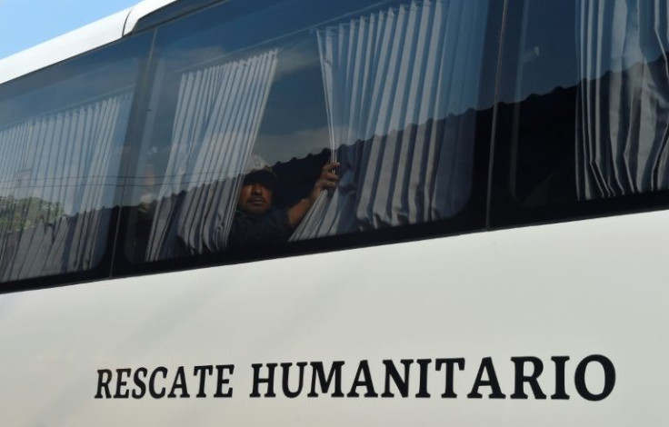 Migrants wait on a bus in southern Mexico after accepting an offer from the immigration authorities to apply for a one-year residency permit on humanitarian grounds