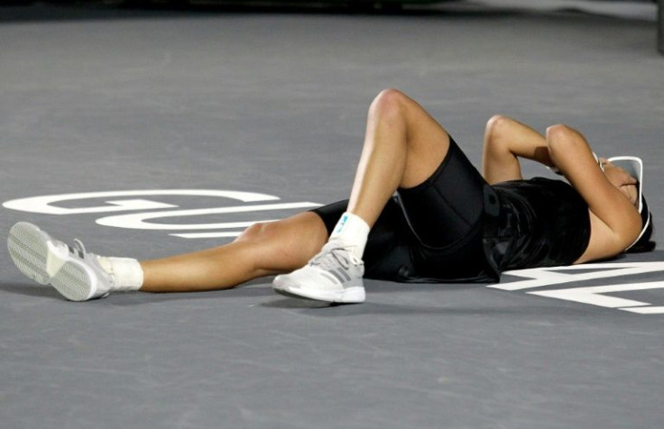 Spain's Garbine Muguruza celebrates after beating Estonian Anett Kontaveit in the championship match of the WTA Finals