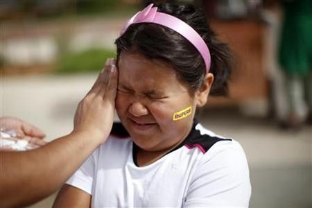 Fernanda Garcia-Villanueva, 8, has sunscreen applied before the annual runwalk for patients and their friends and families at The Childrens Hospital