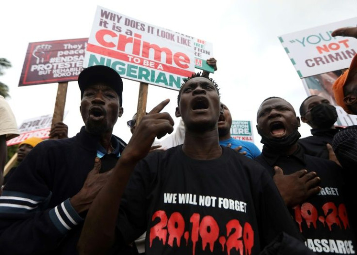Protesters in Abuja gather in October 2021 with placards to commemorate one year after the police crackdown on Nigeria's EndSars mass demonstrations