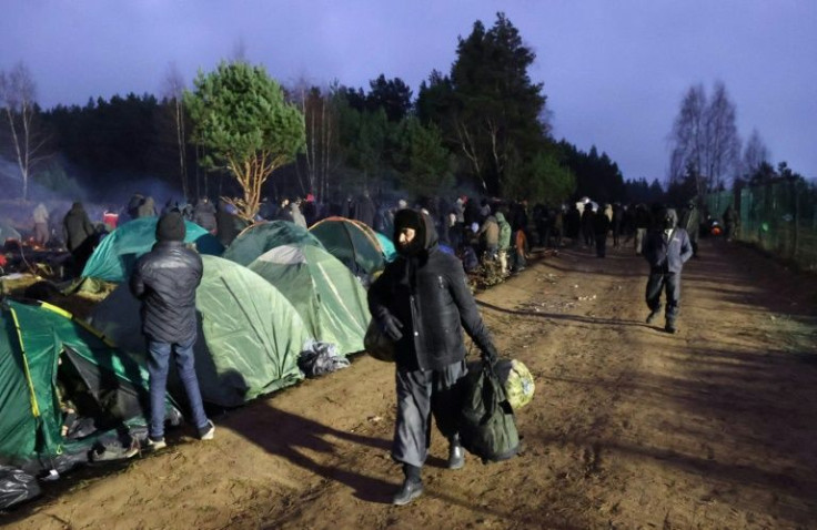 Migrants aiming to cross into Poland camp on the Belarusian-Polish border on November 18, 2021