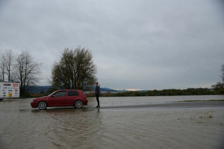Peter Epp, a resident of Abbotsford, is seen observing flooding in the Sumas area of Abbotsford, British Columbia south of a closed Hwy 1. Rail and highway links to Vancouver were briefly reopened by emergency crews clearing debris, allowing travellers st