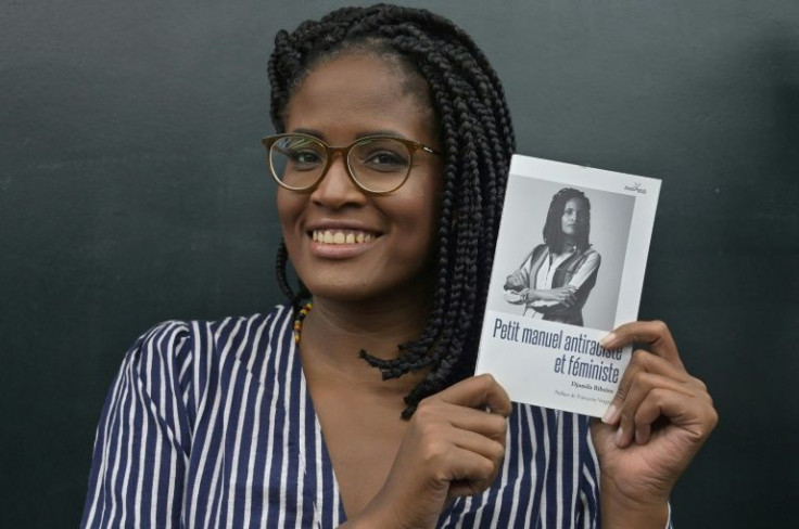 Brazilian philosopher and writer Djamila Ribeiro holds her book "Small Anti-Racist Manualâ during an interview with AFP in Sao Paulo, Brazil, on November 8, 2021
