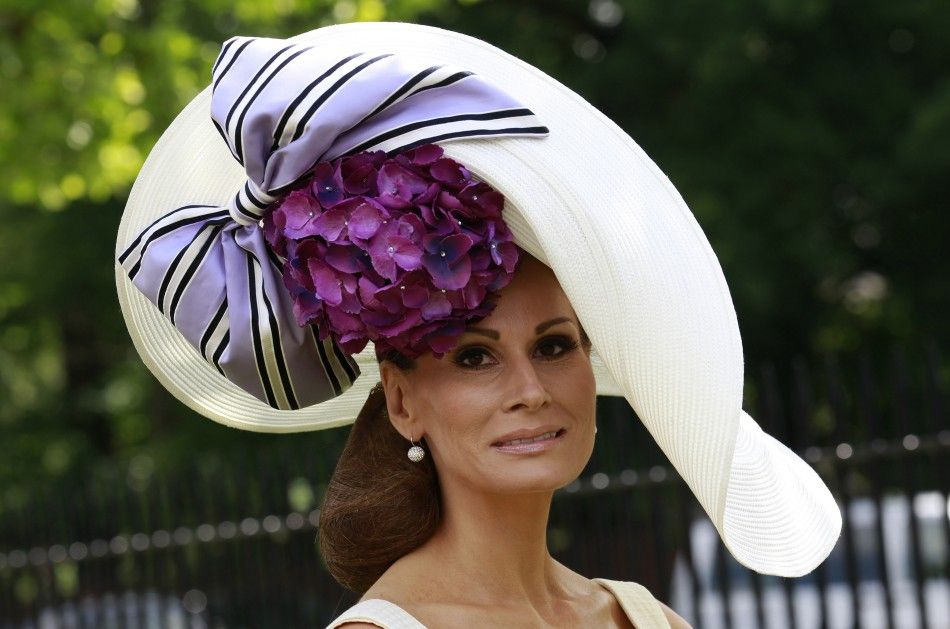 A racegoer models her hat on the first day of racing at Royal Ascot in southern England
