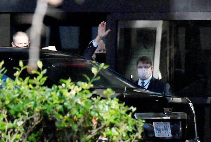 US President Joe Biden waves as he arrives at Walter Reed Medical Center for his annual physical