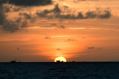 Fishing boats line the horizon at sunrise off the coast of Vietnam's southern Phu Quoc island