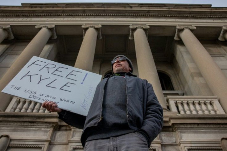 Kyle Rittenhouse has supporters -- a man holds a "Free Kyleâ sign the teen was found not guilty in Kenosha, Wisconsin